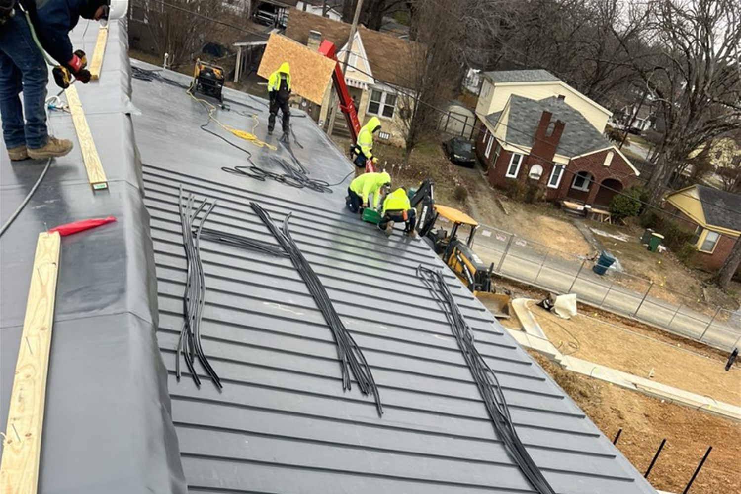 T.F. Thompson Company Roofing crew installing a standing seam metal roof